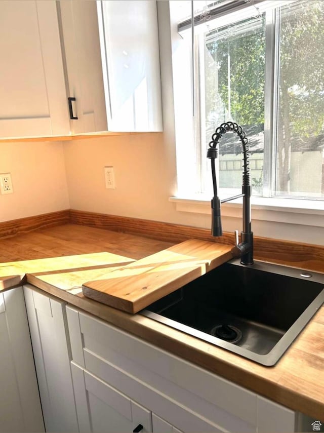 330 E 300 N, Price, UT 84501 - interior details with wood counters, baseboards, white cabinets, and a sink