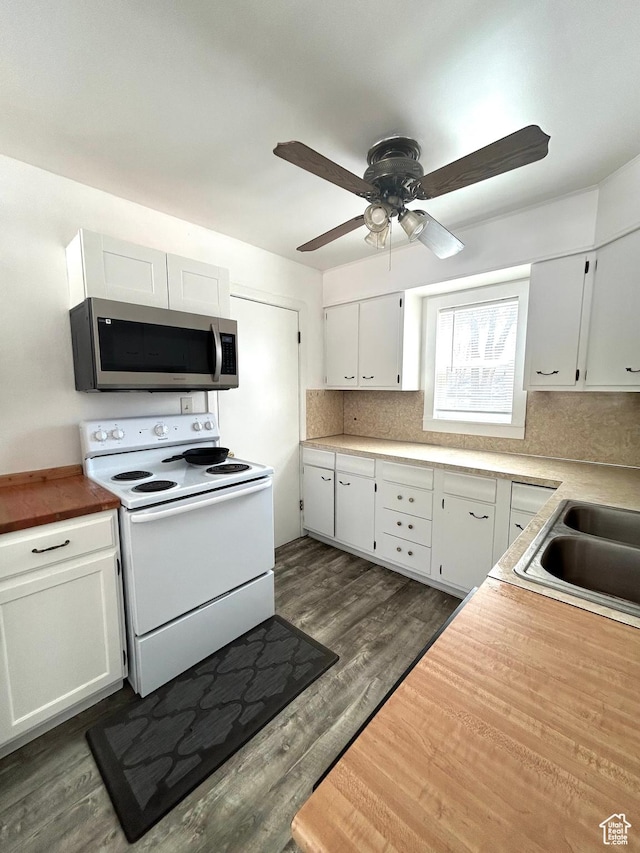 330 E 300 N, Price, UT 84501 - kitchen featuring stainless steel microwave, white electric range oven, backsplash, dark wood-style floors, and white cabinets