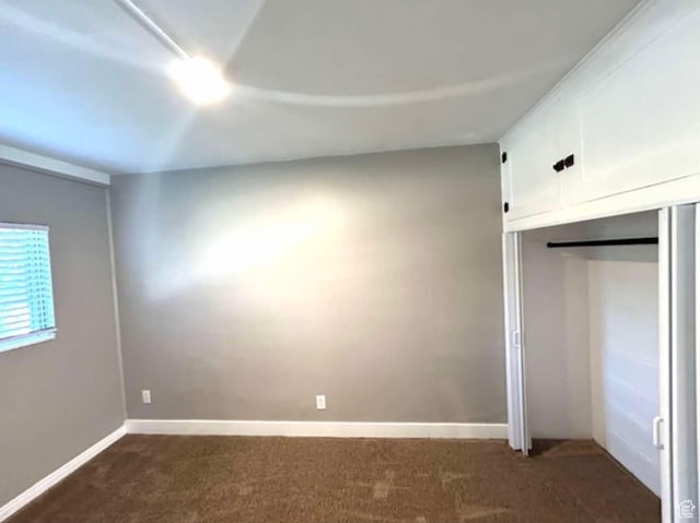 330 E 300 N, Price, UT 84501 - unfurnished bedroom featuring baseboards, a closet, and dark carpet