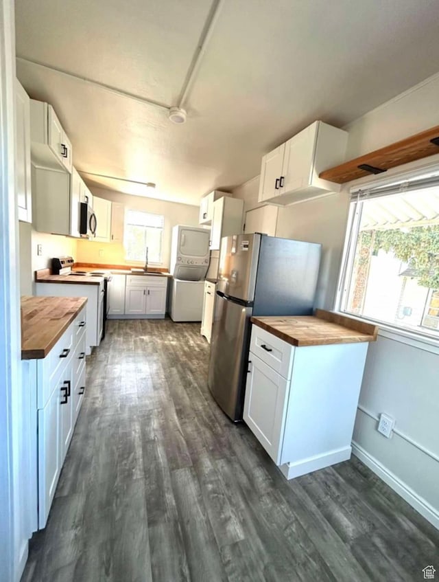 330 E 300 N, Price, UT 84501 - kitchen with dark wood-style flooring, wooden counters, stainless steel appliances, and stacked washer and clothes dryer