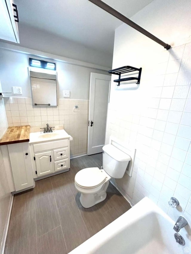 330 E 300 N, Price, UT 84501 - bathroom featuring shower / bath combination, vanity, tile walls, and toilet