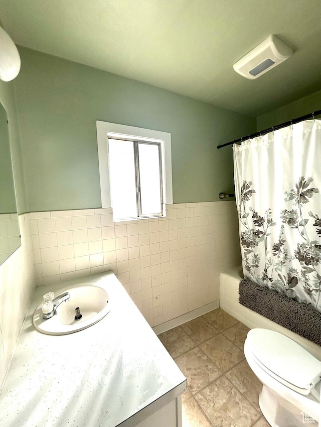 330 E 300 N, Price, UT 84501 - bathroom featuring tile walls, toilet, shower / tub combo with curtain, wainscoting, and vanity