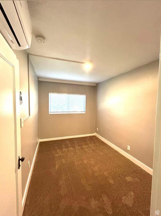 330 E 300 N, Price, UT 84501 - spare room featuring baseboards, dark colored carpet, and an AC wall unit