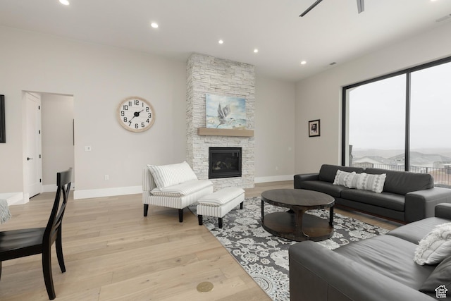 3311 E Barrel Roll Dr, St George, UT 84790 - living room featuring a stone fireplace, light wood finished floors, recessed lighting, and baseboards