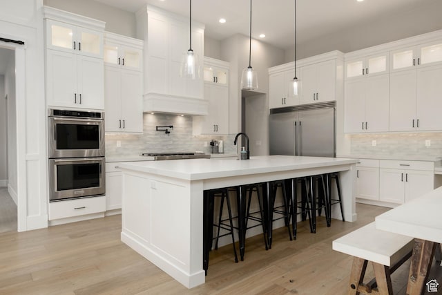 3311 E Barrel Roll Dr, St George, UT 84790 - kitchen featuring white cabinets, a center island with sink, appliances with stainless steel finishes, and light countertops