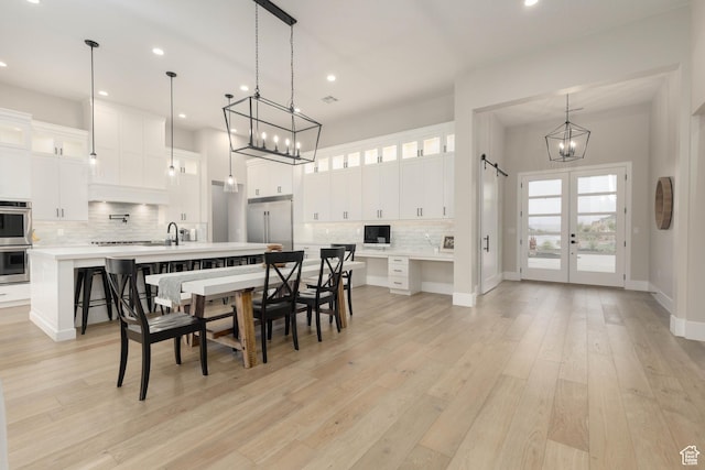 3311 E Barrel Roll Dr, St George, UT 84790 - dining room with french doors, a notable chandelier, recessed lighting, light wood-style floors, and baseboards