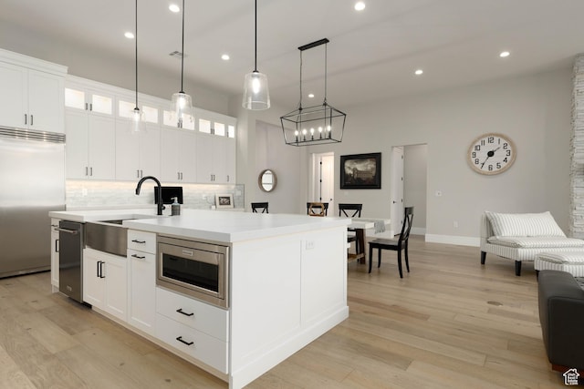 3311 E Barrel Roll Dr, St George, UT 84790 - kitchen with an island with sink, glass insert cabinets, white cabinets, and built in appliances