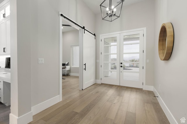 3311 E Barrel Roll Dr, St George, UT 84790 - foyer featuring baseboards, a healthy amount of sunlight, light wood finished floors, and a barn door