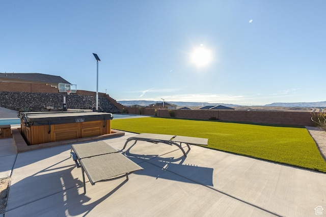 3311 E Barrel Roll Dr, St George, UT 84790 - view of patio / terrace with a hot tub, a mountain view, and a fenced backyard