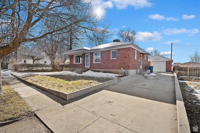 867 33rd St, Ogden, UT 84403 - view of front of home featuring driveway, a garage, a chimney, an outbuilding, and brick siding