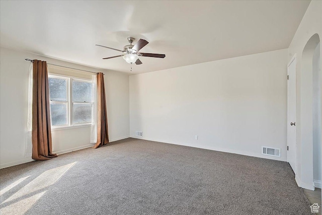 867 33rd St, Ogden, UT 84403 - carpeted spare room featuring baseboards, visible vents, arched walkways, and a ceiling fan