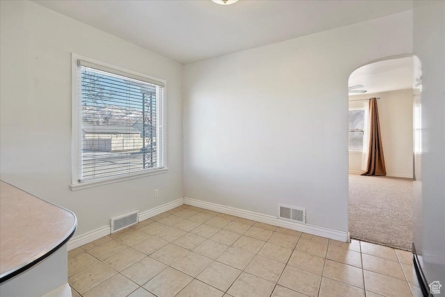 867 33rd St, Ogden, UT 84403 - spare room featuring arched walkways, visible vents, baseboards, and light tile patterned flooring