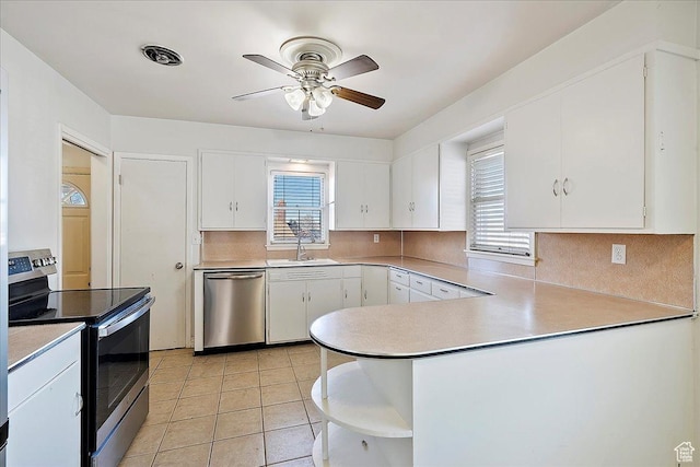867 33rd St, Ogden, UT 84403 - kitchen with stainless steel appliances, light countertops, white cabinetry, and a sink