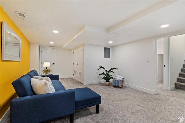 living area featuring baseboards, visible vents, light colored carpet, stairway, and recessed lighting
