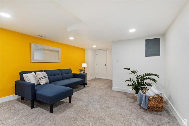 living room with electric panel, visible vents, baseboards, light colored carpet, and recessed lighting