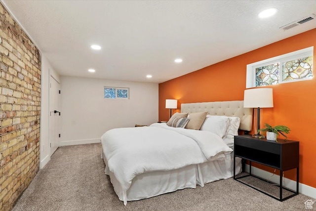 carpeted bedroom featuring multiple windows, visible vents, and recessed lighting