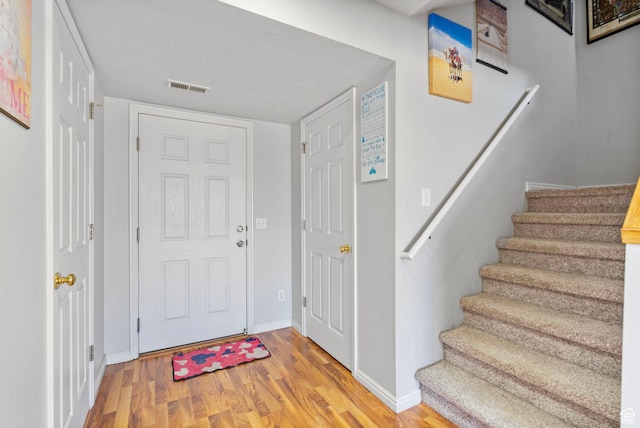 1486 S Archmore Loop, Springville, UT 84663 - foyer entrance featuring stairs, light wood finished floors, visible vents, and baseboards