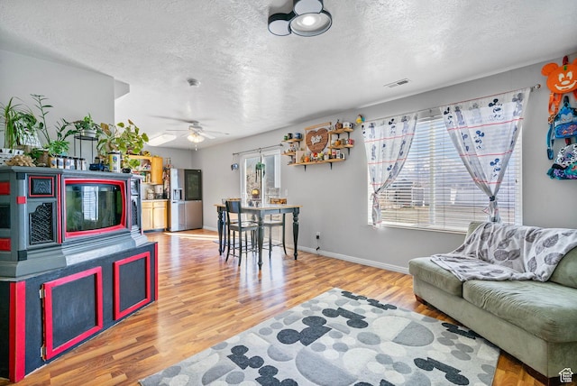 1486 S Archmore Loop, Springville, UT 84663 - living room with a textured ceiling, wood finished floors, visible vents, and baseboards