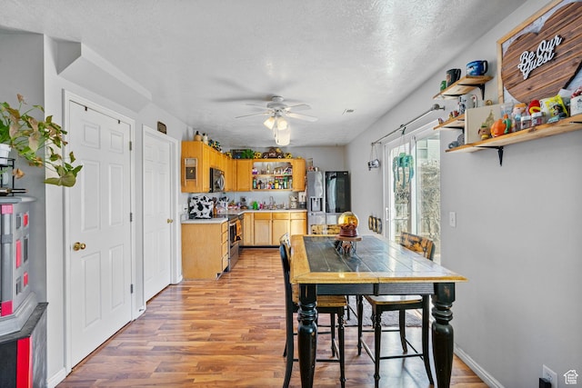 1486 S Archmore Loop, Springville, UT 84663 - dining area featuring ceiling fan, light wood-style flooring, and a textured ceiling