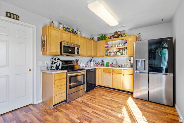1486 S Archmore Loop, Springville, UT 84663 - kitchen with stainless steel appliances, a sink, light countertops, light wood-type flooring, and open shelves