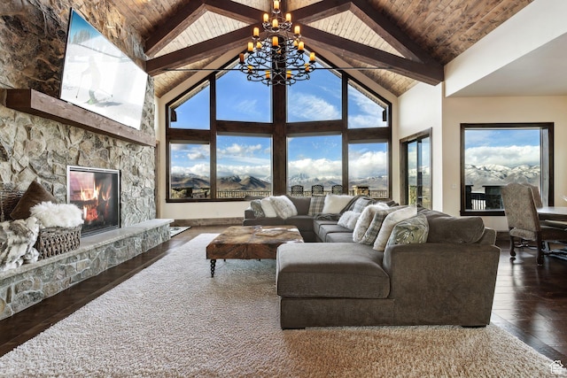 3203 E Kings Crest Ct, Heber City, UT 84032 - living room with a notable chandelier, dark wood-type flooring, wood ceiling, a stone fireplace, and beamed ceiling