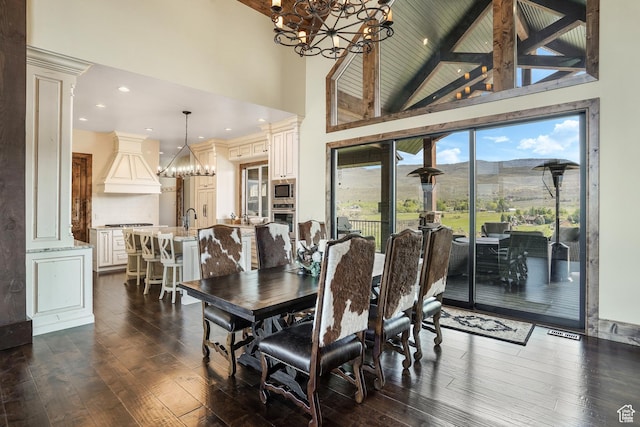 3203 E Kings Crest Ct, Heber City, UT 84032 - dining area featuring dark wood finished floors, high vaulted ceiling, a mountain view, a chandelier, and beamed ceiling