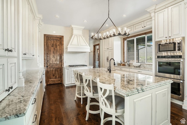 3203 E Kings Crest Ct, Heber City, UT 84032 - kitchen with hanging light fixtures, a sink, a center island with sink, and custom range hood
