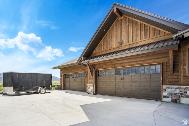 3203 E Kings Crest Ct, Heber City, UT 84032 - view of home's exterior featuring metal roof, a garage, stone siding, board and batten siding, and a standing seam roof