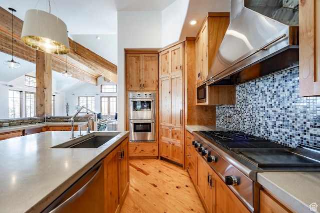 2667 Aspen Springs Dr, Park City, UT 84060 - kitchen with stainless steel appliances, range hood, a sink, light wood-style flooring, and tasteful backsplash