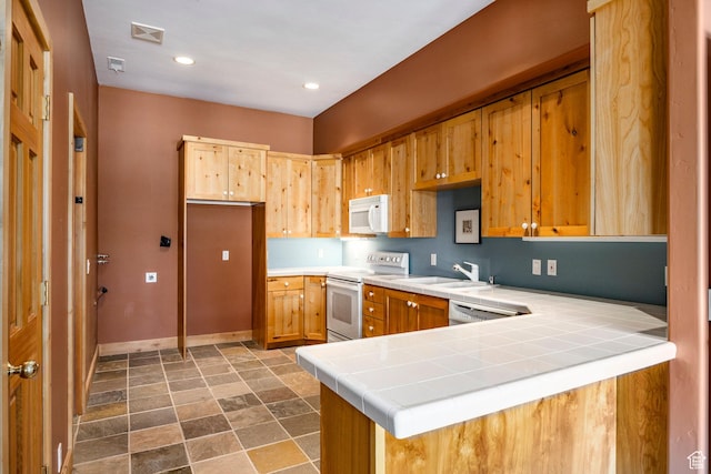 2667 Aspen Springs Dr, Park City, UT 84060 - kitchen with white appliances, stone finish flooring, baseboards, a peninsula, and tile counters