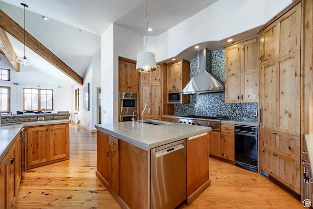 2667 Aspen Springs Dr, Park City, UT 84060 - kitchen with wall chimney exhaust hood, a sink, appliances with stainless steel finishes, light wood finished floors, and recessed lighting