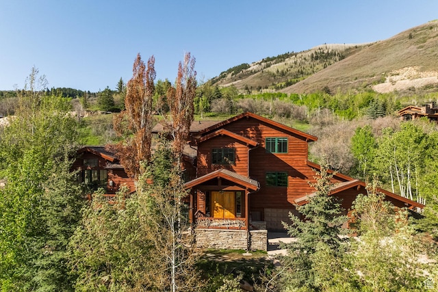 2667 Aspen Springs Dr, Park City, UT 84060 - view of front of home featuring a garage, stone siding, and a mountain view