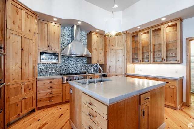 2667 Aspen Springs Dr, Park City, UT 84060 - kitchen with wall chimney exhaust hood, stainless steel appliances, light wood finished floors, decorative backsplash, and recessed lighting