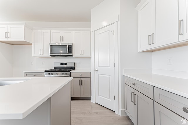 712 W 4500 S Unit 304, Mapleton, UT 84664 - kitchen featuring appliances with stainless steel finishes, light countertops, and white cabinets