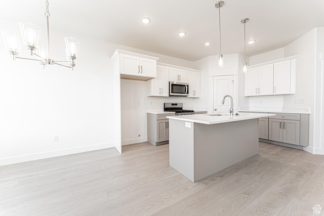 712 W 4500 S Unit 304, Mapleton, UT 84664 - kitchen featuring stainless steel microwave, light wood-type flooring, a chandelier, a sink, and stove