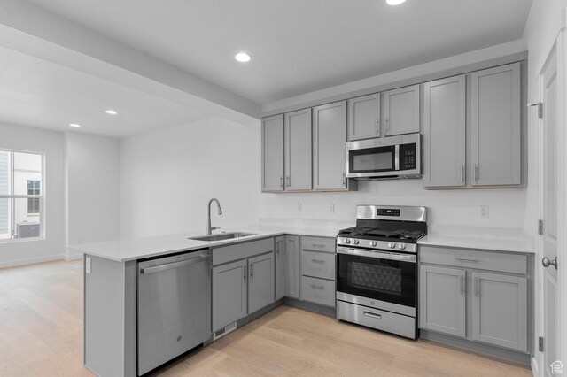 1819 N 3530 W, Lehi, UT 84043 - kitchen with a peninsula, appliances with stainless steel finishes, gray cabinets, and a sink