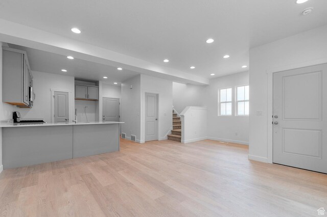 1819 N 3530 W, Lehi, UT 84043 - unfurnished living room featuring recessed lighting, stairway, and light wood finished floors