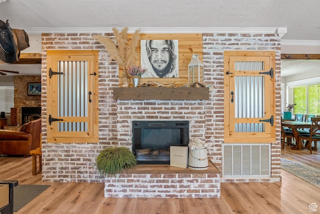 1502 S 325 W, Hurricane, UT 84737 - living area with a brick fireplace, visible vents, and crown molding