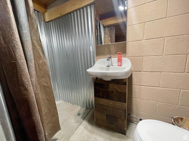 1502 S 325 W, Hurricane, UT 84737 - bathroom featuring concrete block wall, a sink, toilet, and concrete flooring