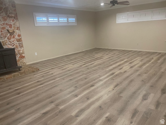 1502 S 325 W, Hurricane, UT 84737 - below grade area with a wood stove, light wood finished floors, ceiling fan, and baseboards