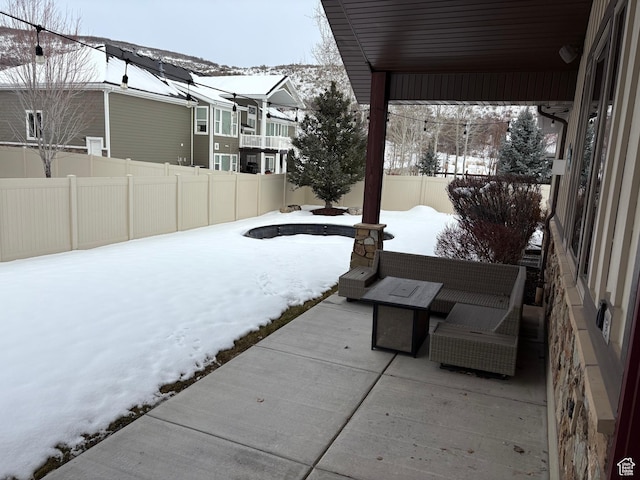 5818 Cambridge Dr, Mountain Green, UT 84050 - snow covered patio with an outdoor hangout area and a fenced backyard