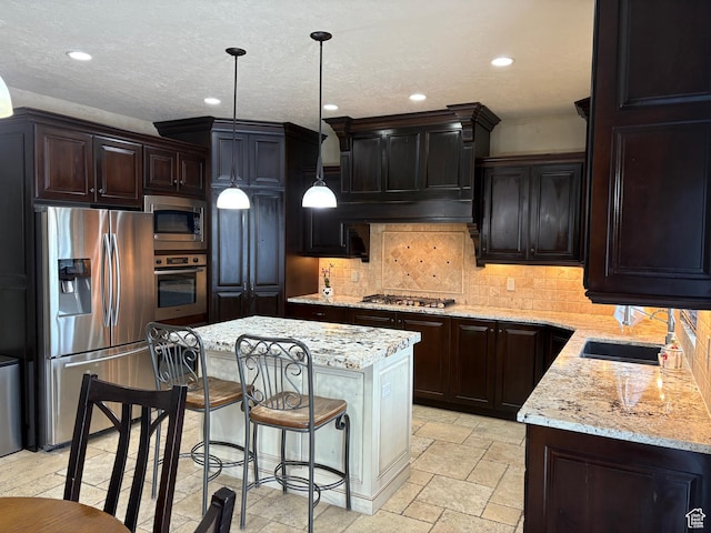 5818 Cambridge Dr, Mountain Green, UT 84050 - kitchen featuring light stone counters, tasteful backsplash, appliances with stainless steel finishes, a center island, and recessed lighting