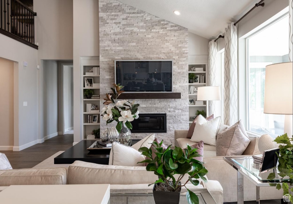 6343 W Teton Ranch Dr Unit 315, Herriman, UT 84096 - living room with baseboards, wood finished floors, a wealth of natural light, and a stone fireplace