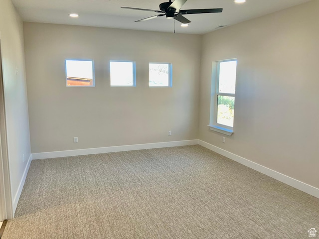 unfurnished room with a ceiling fan, recessed lighting, light colored carpet, and baseboards