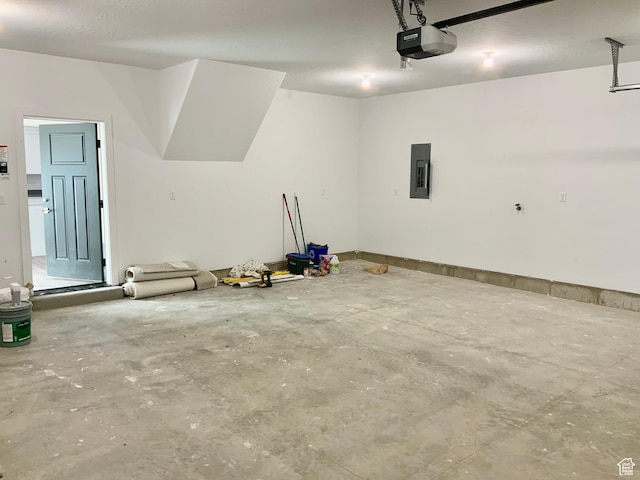 garage featuring electric panel and a garage door opener