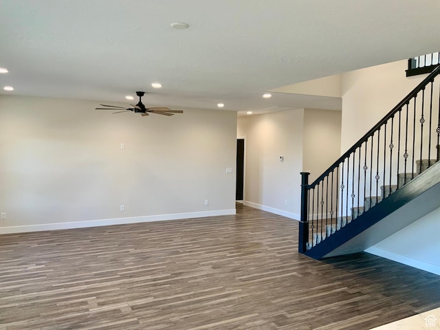 empty room featuring stairs, recessed lighting, baseboards, and wood finished floors
