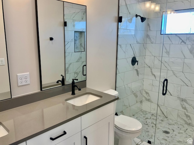bathroom featuring toilet, a shower stall, and vanity