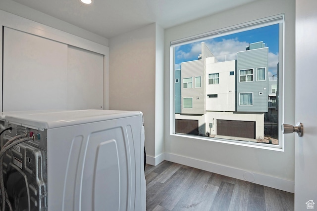 laundry room with washer / clothes dryer, baseboards, dark wood-style flooring, and laundry area