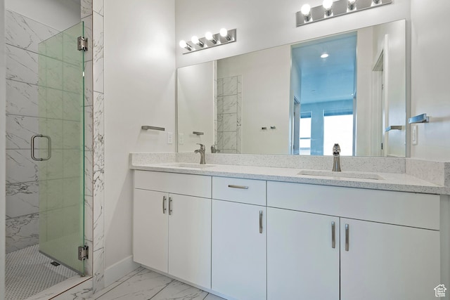 bathroom with marble finish floor, a sink, a marble finish shower, and double vanity