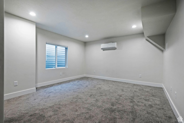 basement with carpet, baseboards, and a wall mounted AC